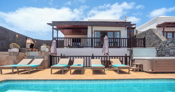 A heated pool, sun loungers