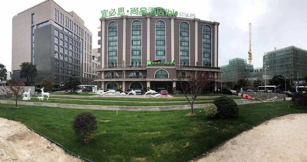 A hotel with a central courtyard, multiple floors, and a modern architectural style.