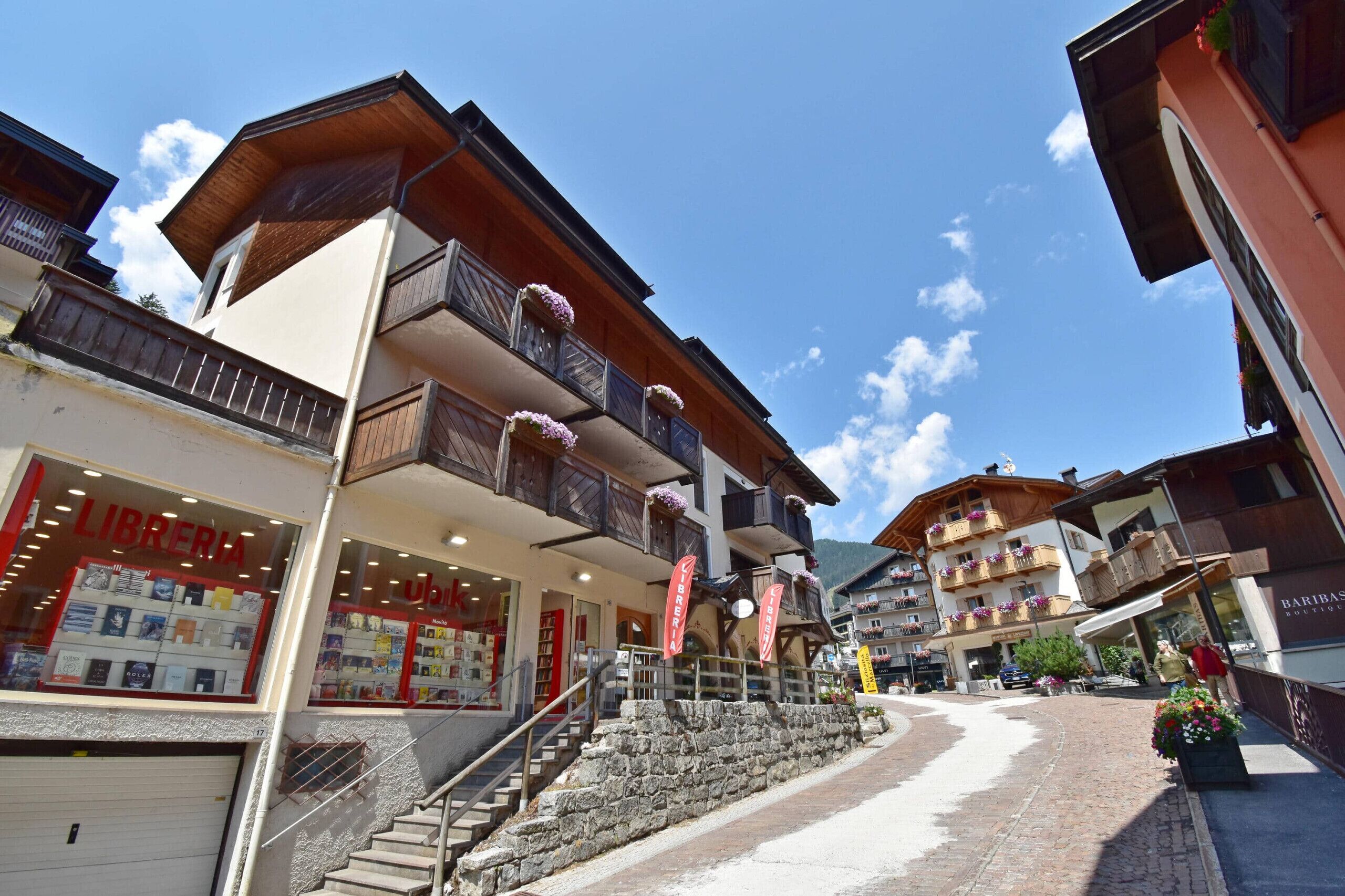 A multi-story building with balconies, a bookstore, and a bar.