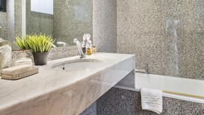A modern bathroom with a granite countertop, a sink, a mirror, a shower, and a towel rack. - My Space Barcelona 9 Apart has 54 people with optional parking in the center (Barcelona)