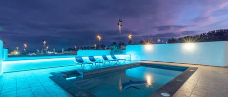 A heated pool, pool loungers