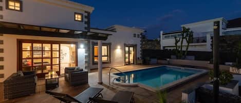 A heated pool, pool loungers