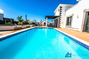 A heated pool, pool loungers