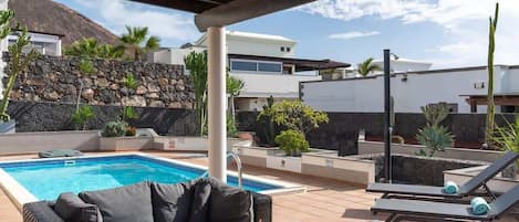 A heated pool, pool loungers