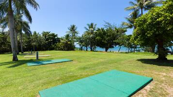 A grassy area with exercise mats and a clear view of the sea.