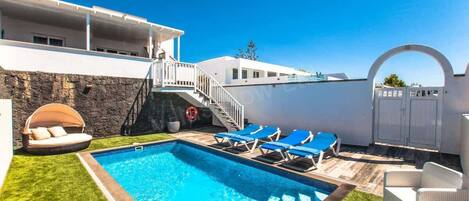 A heated pool, pool loungers