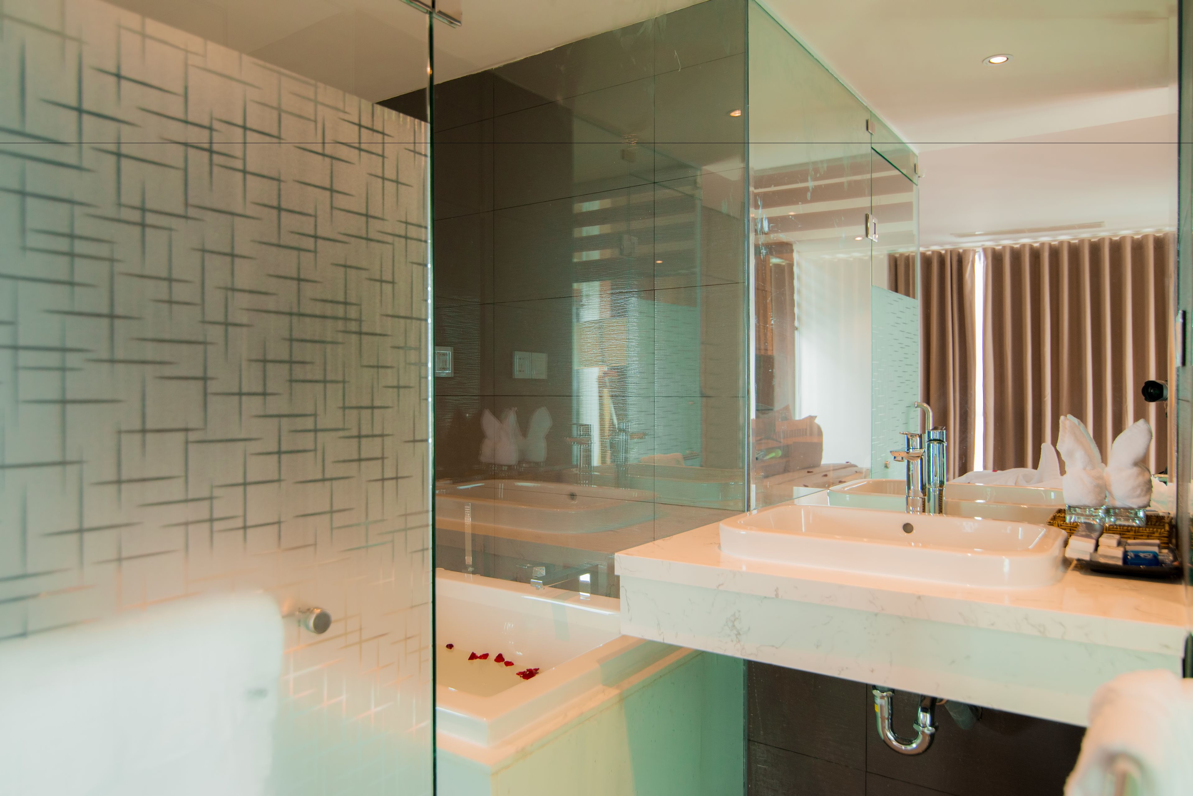 deluxe triple room | bathroom | rainfall showerhead, free toiletries, hair dryer, slippers