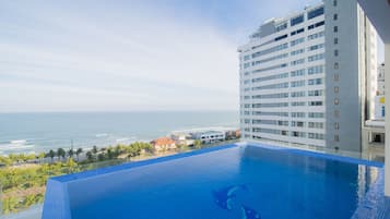 Outdoor pool, open 6 AM to 9 PM, pool umbrellas, pool loungers