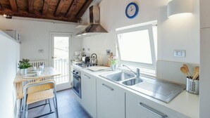 A compact kitchen with a stove, sink, and window. - Rome, Piazza Navona, characteristic apartment for 5 people (Rome)