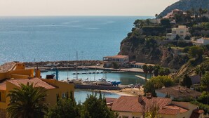 A coastal town with buildings, a marina, and boats. - Villa Encanto - PlusHolidays (Calpe)