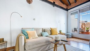 A living room with a sofa, a coffee table, and a floor lamp.