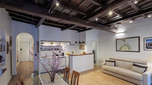 A modern interior with a dining area, sofa, kitchen, and artwork. - Lovely Trastevere - An Authentic Experience .. (Roma)