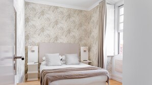A bedroom with a bed, bedside tables, a window, and a door. - Chiado | CHARMING & ROMANTIC | Family-Friendly (Lisboa)