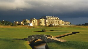 A golf course with a stone bridge and a large building in the background. - Beautiful open plan self-catering cottage surrounded by tranquil woodlands (By Arbroath)