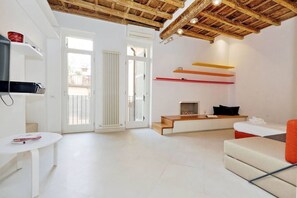 A modern living room with a wooden ceiling, white walls, and a fireplace. - Rome, historical center, characteristic apartment up to 5 people (Roma)
