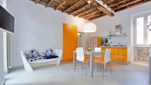 A modern interior with a dining area, kitchen, and seating space. - Rome, historical center, characteristic apartment up to 5 people (Roma)