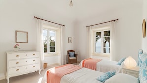 A bedroom with two beds, a dresser, a chair, and a nightstand. - Funchal Character Villa, Seaview | Quinta Alegria (Funchal)