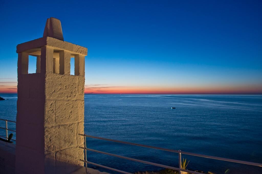 A coastal view with a stone structure overlooking the sea.