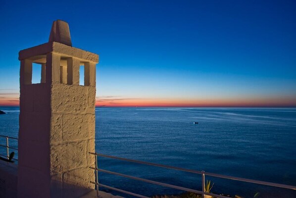 A coastal view with a stone structure overlooking the sea.