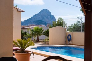 A pool area with a mountain view, a fenced garden, and a hose. - Villa Amelia - Plus (Calpe)