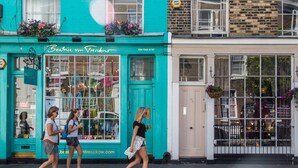 A turquoise storefront with a sign reading "Beatrice von Vresckow" and a website address.
