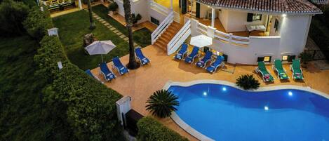 A heated pool, sun loungers