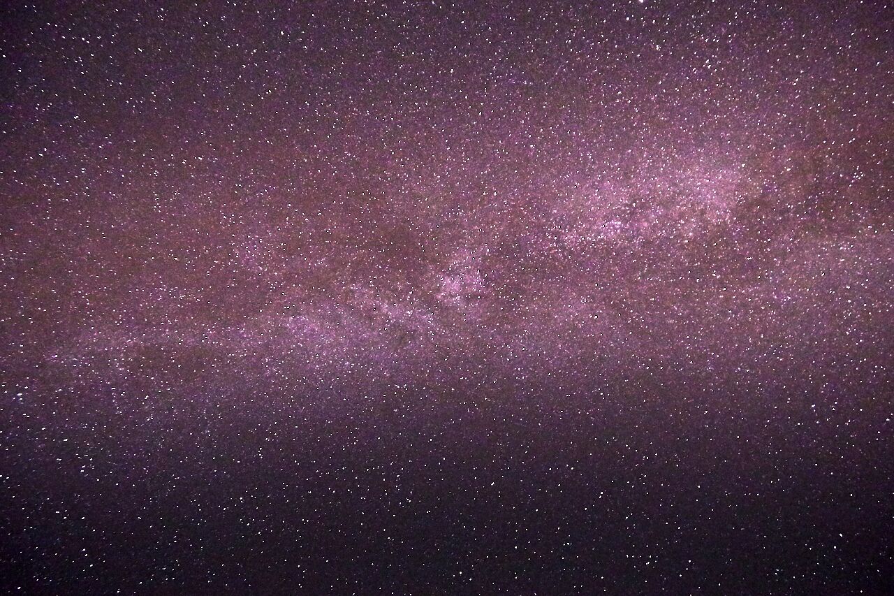 A starry night sky with a dense cluster of stars.