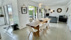 A modern, open-plan living space with a dining area, kitchen, and seating area.