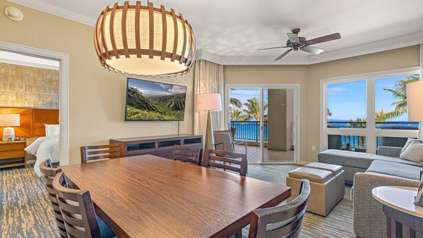 A hotel room with a dining area, a sofa, a ceiling fan, and a view of the ocean. - Maui Resort Rentals: Westin Ka'anapali Ocean Resort 2BR Direct Oceanfront Villa (Lahaina)