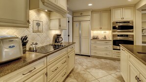A kitchen with white cabinetry, a refrigerator, a coffee maker, and a toaster. - 21 Windjammer-Private Pool, views of the 10th tee of Harbour Town Golf Links (Hilton Head Island)