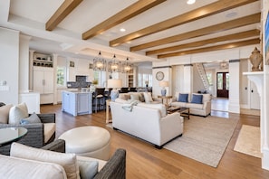 A spacious living area with a kitchen, dining area, and a staircase leading to another level. - 31A Dune Lane - This DIRECT oceanfront home will take your breath away! (Hilton Head Island)