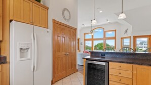 A kitchen with wooden cabinets, a built-in refrigerator, a dishwasher, and large windows offering a view of the outdoors. - As Time Goes By: Dog-friendly, Elevator, Pool, Hot Tub (Corolla)