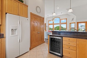 A kitchen with wooden cabinets, a built-in refrigerator, a dishwasher, and large windows offering a view of the outdoors. - As Time Goes By: Dog-friendly, Elevator, Pool, Hot Tub (Corolla)
