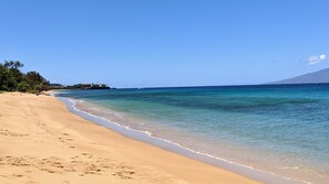 Enjoy a serene beach experience with access to clear blue waters and a sandy shore.