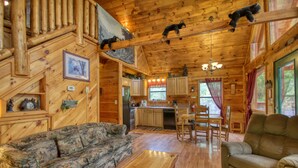 A log cabin interior with a living room, kitchen, and dining area. - Privacy~Sunset View~Pet Friendly~Pool Table~Air Hockey (SEVIERVILLE)
