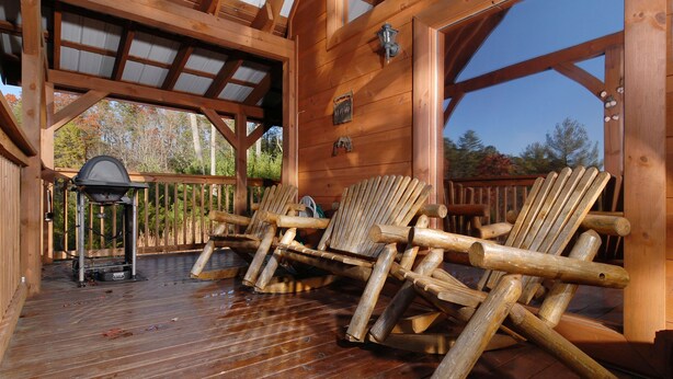 A wooden deck with a grill and chairs. - Privacy~Sunset View~Pet Friendly~Pool Table~Air Hockey (SEVIERVILLE)