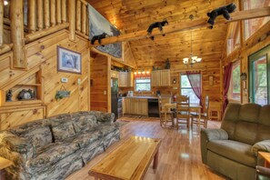 A log cabin interior with a living room, kitchen, and dining area. - Privacy~Sunset View~Pet Friendly~Pool Table~Air Hockey (SEVIERVILLE)