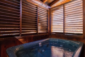 A spa room with a hot tub, wooden slats, and a wooden ceiling. - Pigeon Forge | Pet Friendly | Mountain Views | Hot Tub | Fireplace | WiFi (Pigeon Forge)