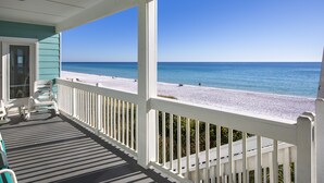 A covered porch with a view of a beach. - Gulf Front Condo, Elevator, Near Shops and Restaurants-Dune Allen Beach (Santa Rosa Beach)