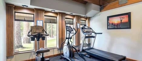 A gym with treadmills, an elliptical, and a stationary bike.