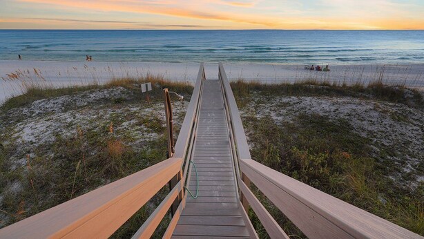 A wooden boardwalk leading to a beach with sand and sparse vegetation. - Las Olas - Oceanfront Vacation Home with Private Pool Space & Gulf Views (Miramar Beach)