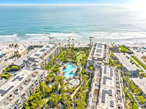 A hotel with a rooftop pool, beach access, and a view of the ocean. - Beautiful ocean views, remodeled 2bdrm penthouse condo, C303 North Coast Village (Oceanside)