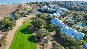 An aerial view of a coastal residential area with houses, a golf course, and a beach. - Screen porch, Golf Course Views, Pool - All right out your door! 39 Linkside (Isle Of Palms)