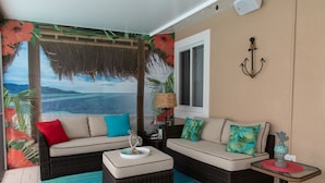 A room with two sofas, a small table, and a wall-mounted lamp. - *Summer Special $2,775 Week* with a private chilled pool & 75' of dockage (Key Colony Beach)