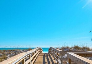 A wooden boardwalk leading to a beach with clear skies. - Gulf View! Coastal Chic! Mainsail 288! (Miramar Beach)