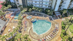 A rooftop pool area with multiple swimming pools, sun loungers, and palm trees. - Gulf View! Coastal Chic! Mainsail 288! (Miramar Beach)