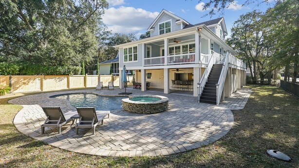 A two-story house with a backyard featuring a swimming pool, a hot tub, and outdoor seating. - 13 Moonshell, Close to Beach, Pool, Big Backyard, Free Golf, Dogs Welcome (Hilton Head)
