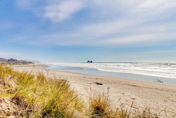 Enjoy a serene beach experience with the sound of waves gently lapping at the shore.