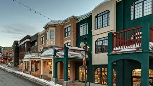 A row of buildings with snow on the roofs, indicating a winter setting.