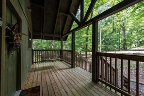 Relax on the deck with a bench and take in the serene forest views.